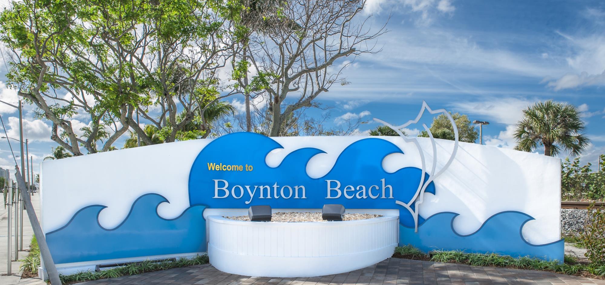 White sign with blue waves with City of Boynton Beach written across