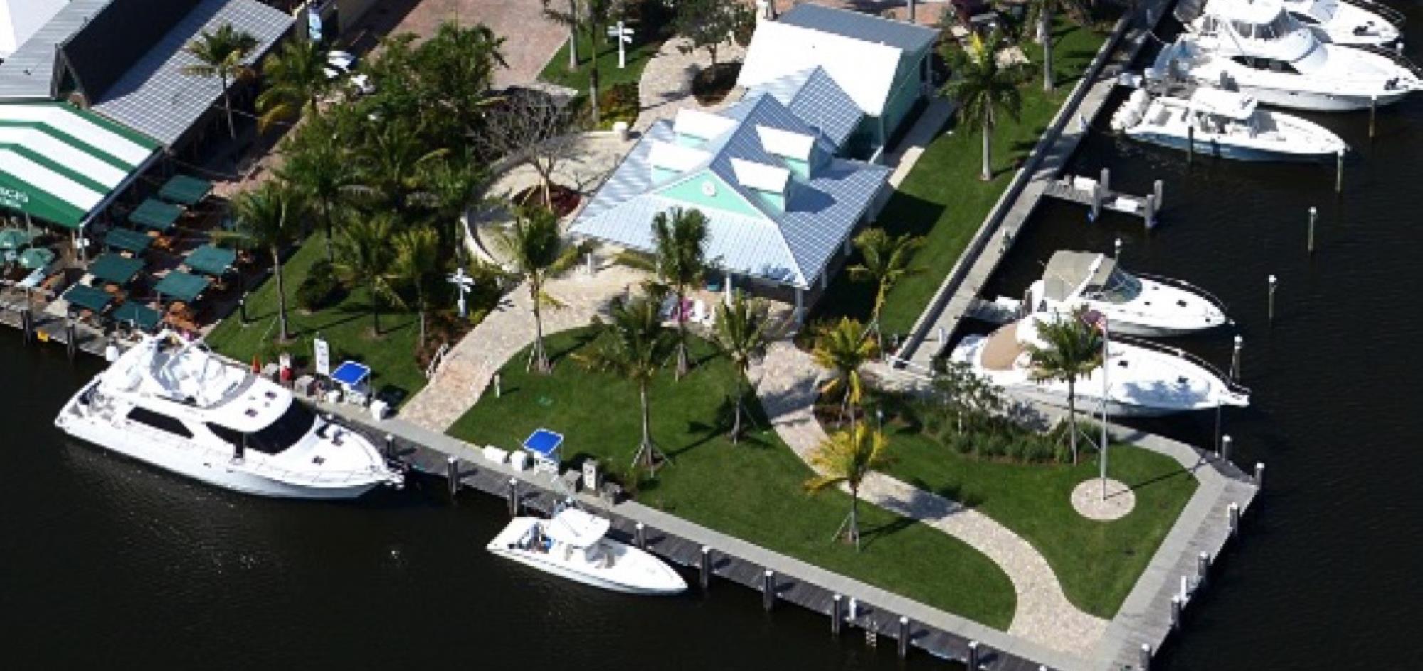 Aerial view of Dockmaster building with Yacht and small boats parked around it