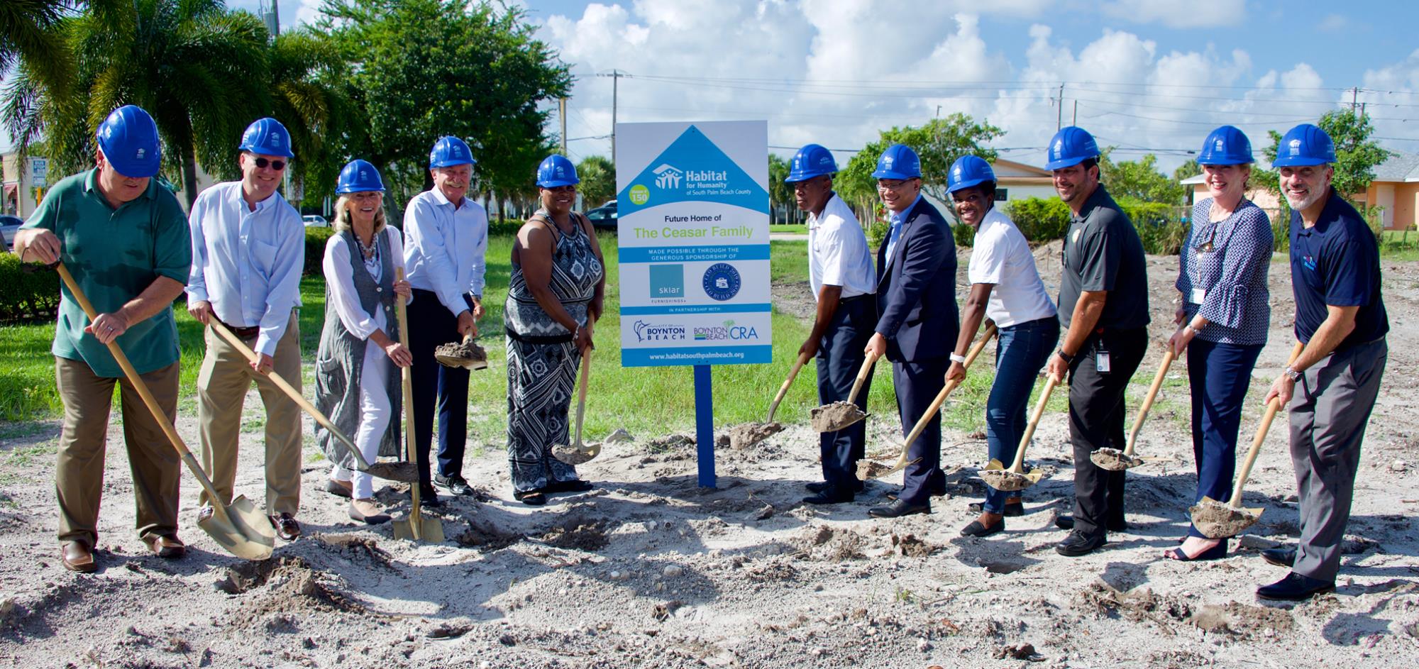Group photo of City Manager, CRA Director, Commissioners and Habitat for Humanity with shovels of dirt for groundbreaking